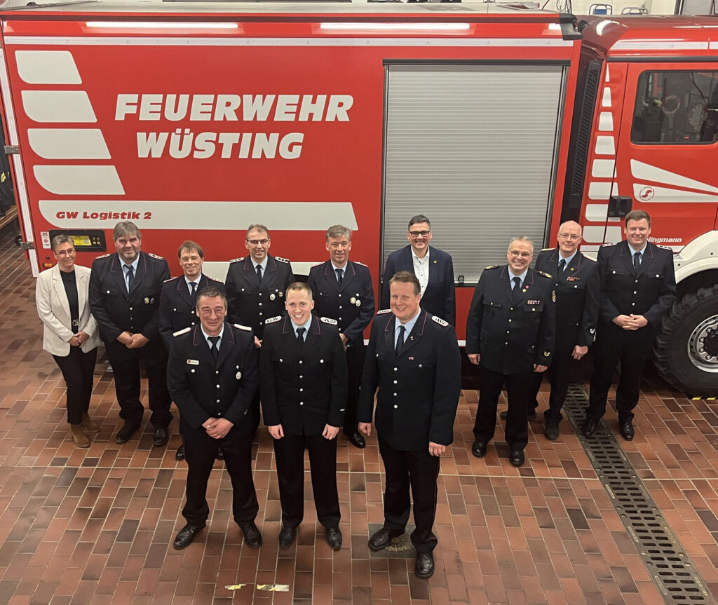 Mitglieder der Ortswehr Wüsting in Uniform vor einem Löschfahrzeug